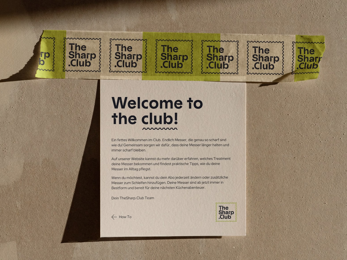 Welcome flyer with a bright-yellow banderole and the headline "Welcome to the club!" on brown cardboard.
